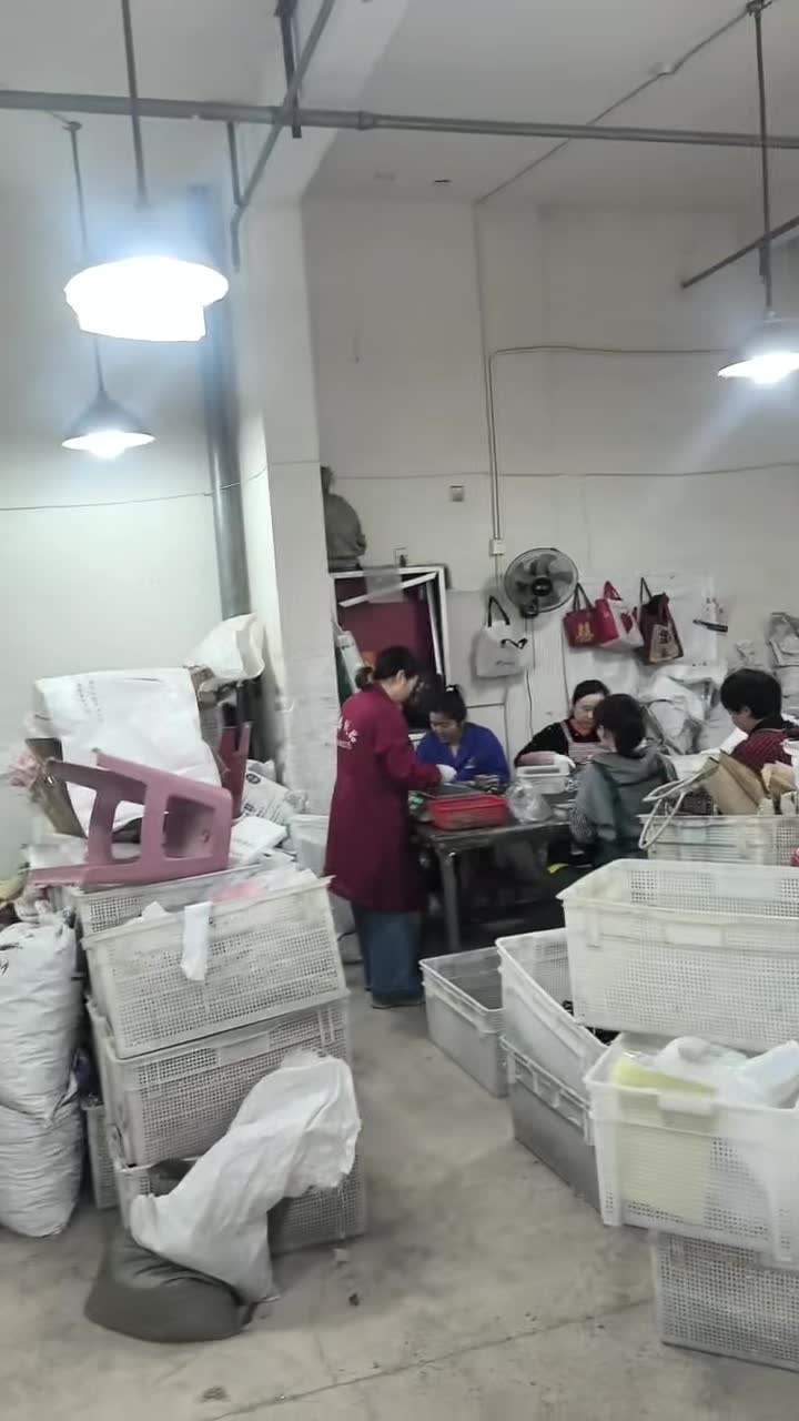 Workers at packing and assembly table in the workshop