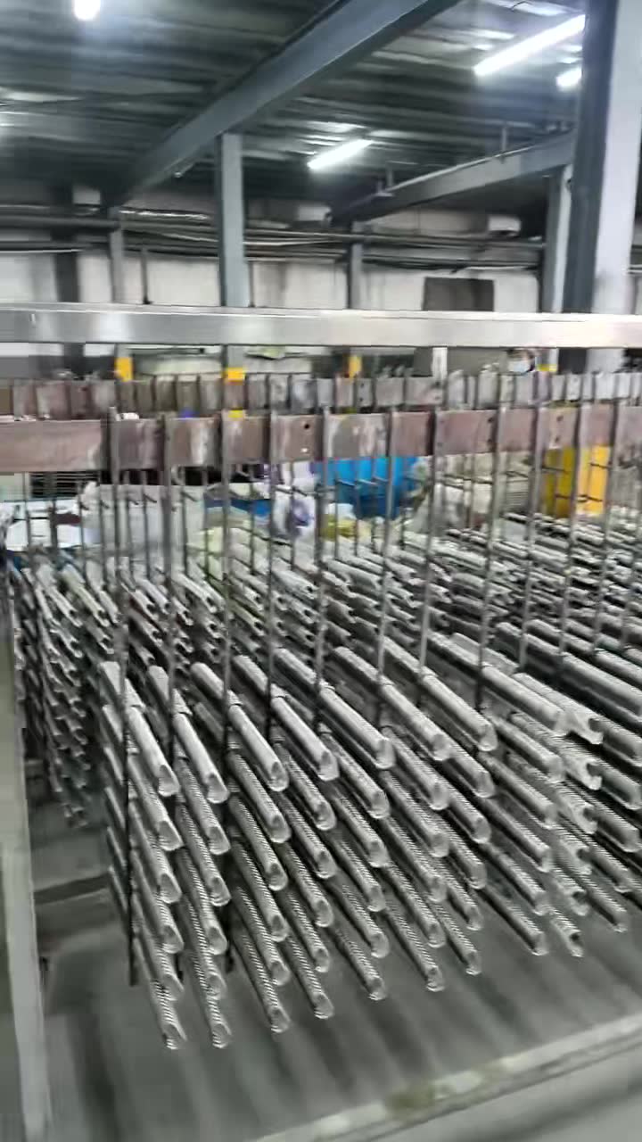 Aluminum carabiner bodies hanging on a production rack